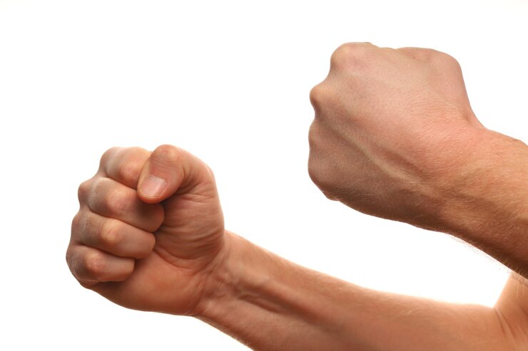 Photo fist isolated on white as a symbol of willpower, resistance and aggression