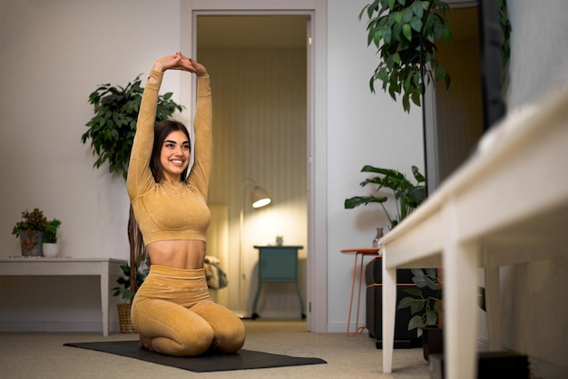 Photo fit active and attractive young person stretching before or after exercise at home maintaining healthy and fit way of living and daily physical activity lifestyle