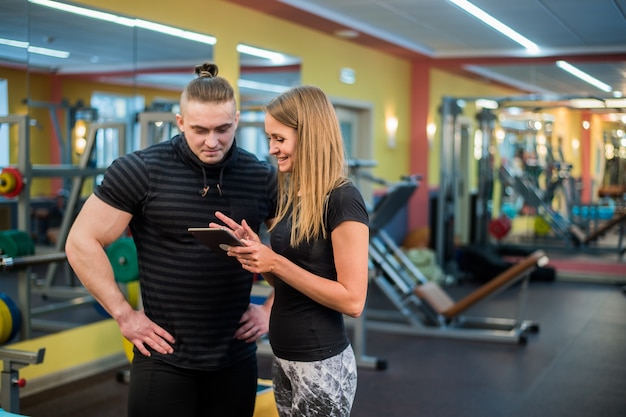 Montare la giovane coppia attraente in una palestra