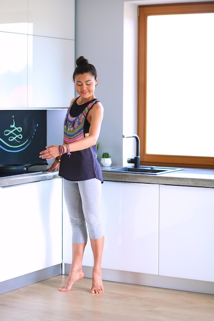 Fit and attractive young woman preparing healthy meal