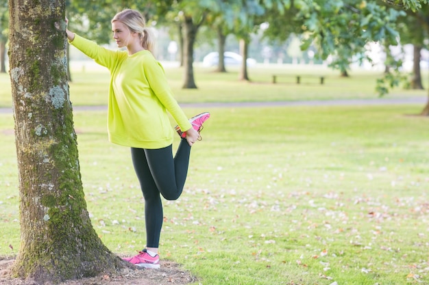 Fit beautiful blonde stretching leg