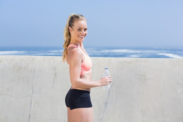 Fit blonde holding water bottle