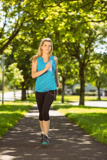 Fit blonde jogging in the park