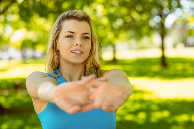 Fit blonde stretching in the park