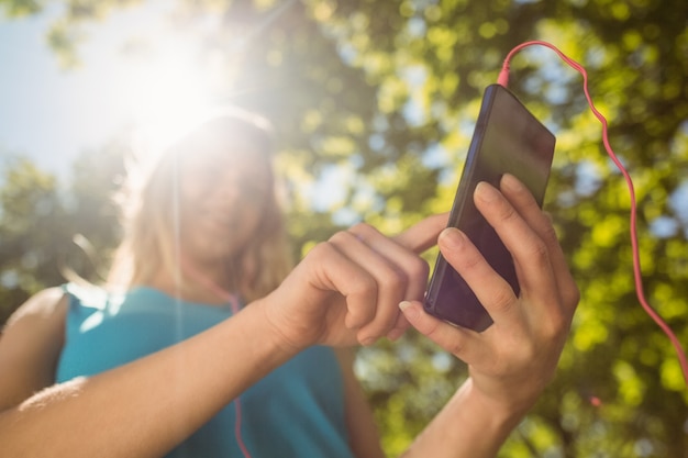 Fit blonde texting on her smartphone