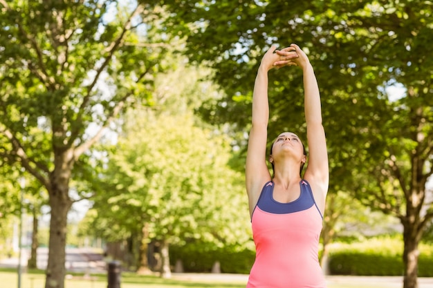 Fit brown hair stretching her arms