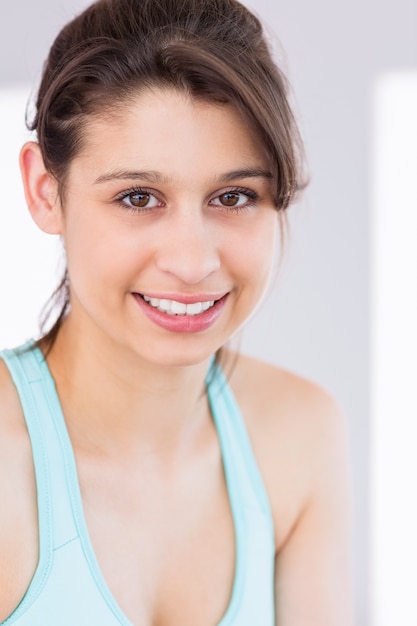 Fit brunette smiling at camera 