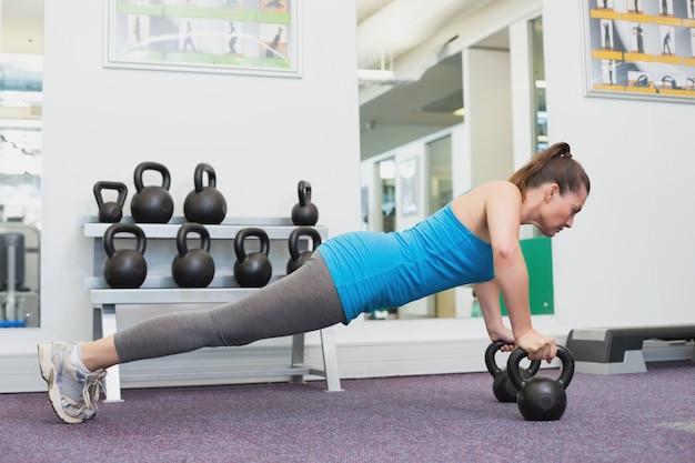 Fit brunette working out with kettlebell 