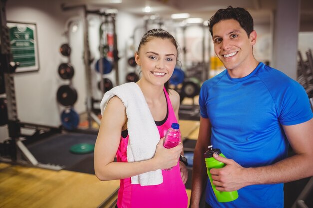 Fit couple smiling at camera