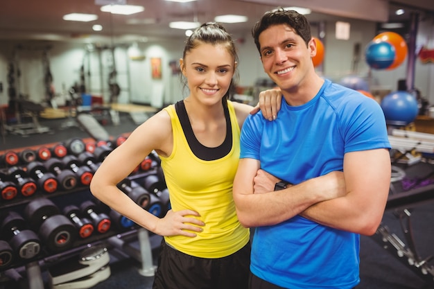 Fit couple smiling at camera