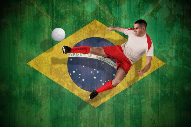 Photo fit football player playing and kicking against brazil flag in grunge effect