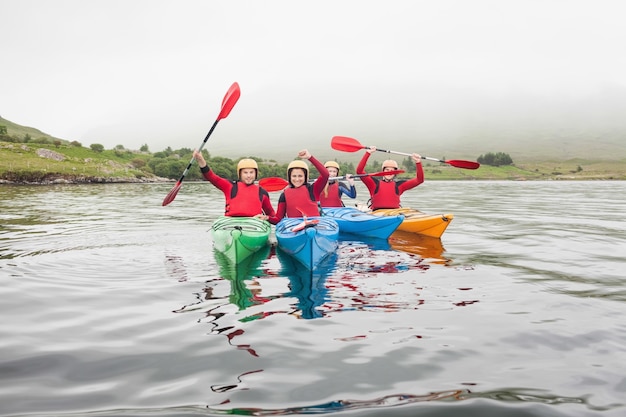 Fit friends rowing on a lake