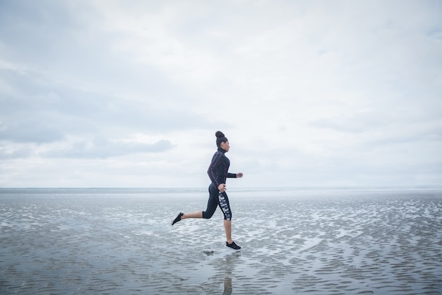 Fit girl jogging on cold day