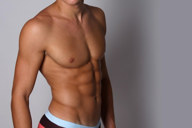 Fit guy with muscular torso. Man sexy bare torso, banner with copy space.