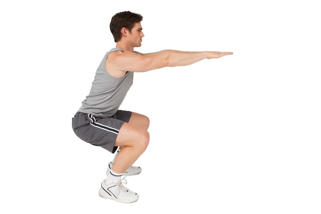 Fit man doing squats