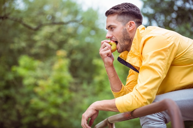 Fit man eating an apple