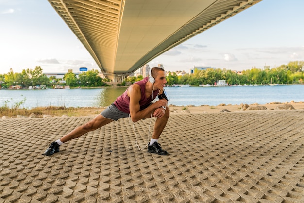 Fit man exercising under the bridge