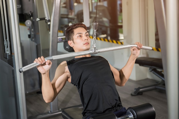 Fit man exercising at the gym on a machine