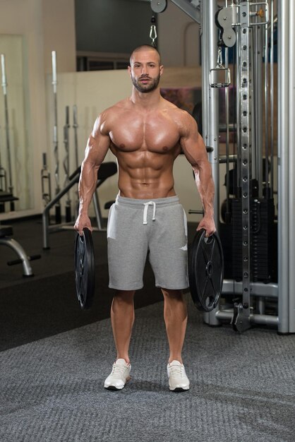 Fit Man Holding Weights In Hand