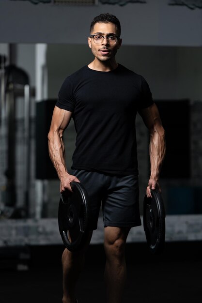 Fit Man Holding Weights in Hand