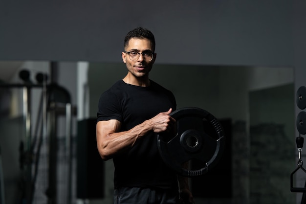 Fit Man Holding Weights in Hand