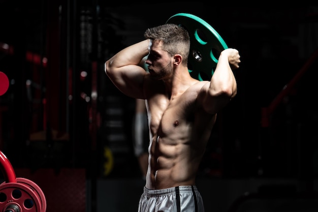Fit Man Holding Weights In Hand