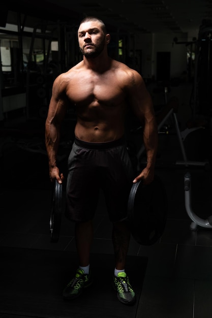 Fit Man Holding Weights In Hand