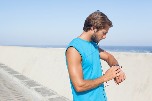 Fit man jogging on promenade