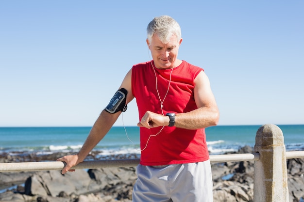 Fit mature man warming up on the pier