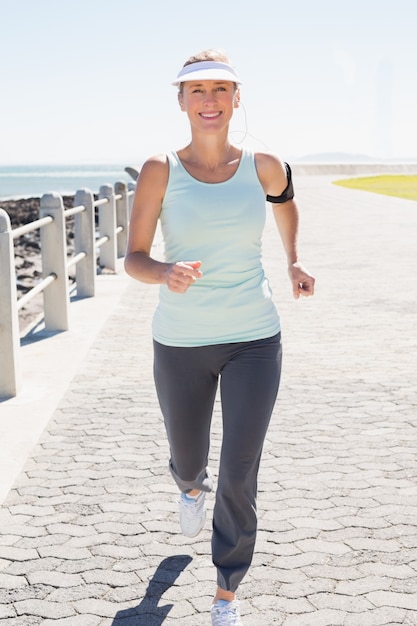 Photo fit mature woman jogging on the pier