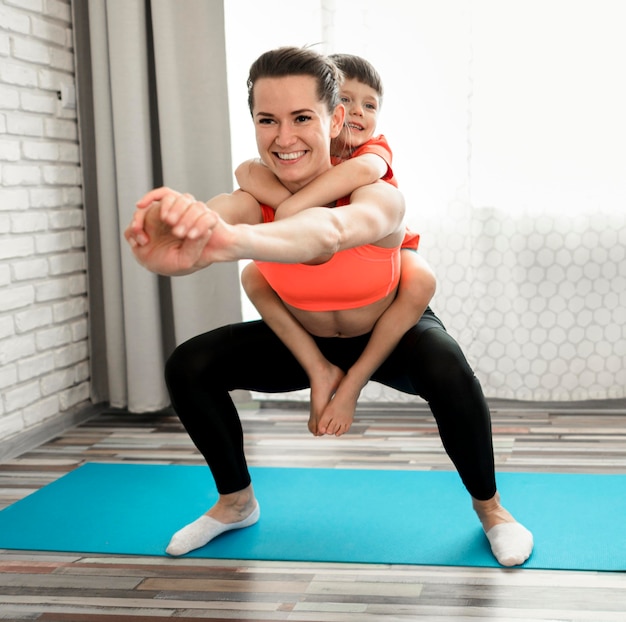 Fit mother exercising together with son