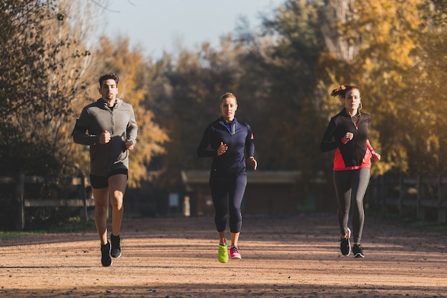 写真 fit people running outdoors