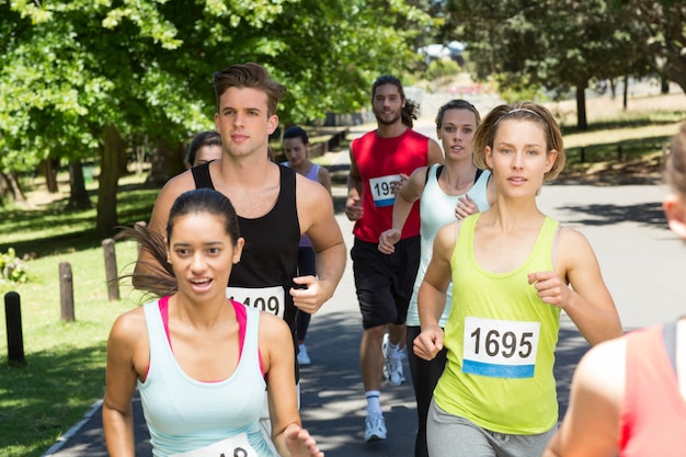 Fit people running race in park