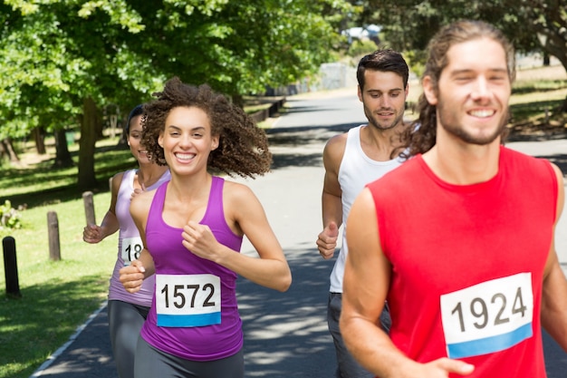 Fit people running race in park