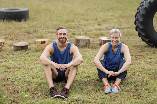 Fit people sitting together in the boot camp