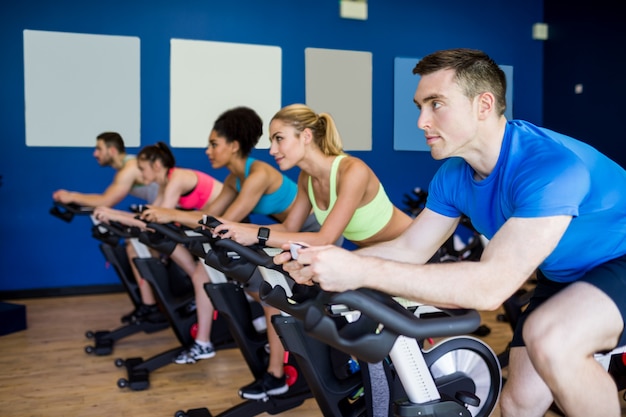 Fit people in a spin class at the gym