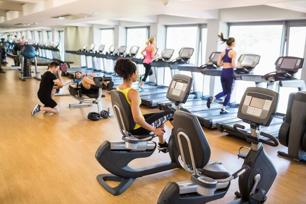 Fit people working out using machines