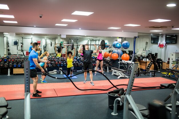 Fit people working out in weights room