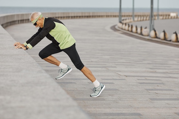 Fit Senior Man Working Out At Seafront