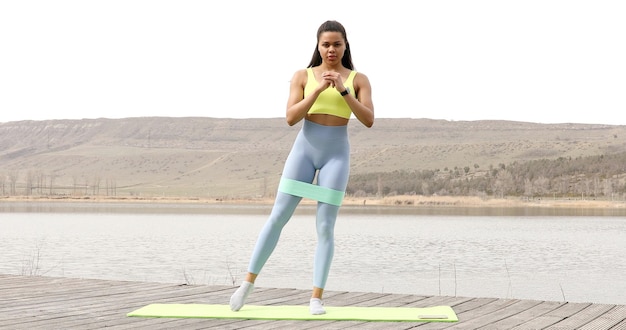 Fit woman doing exercise with resistance band.