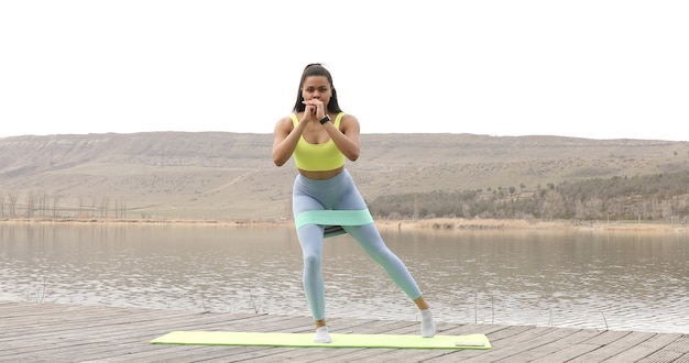 Fit woman doing exercise with resistance band.