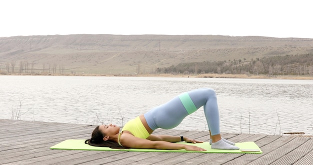 Fit woman doing exercise with resistance band.