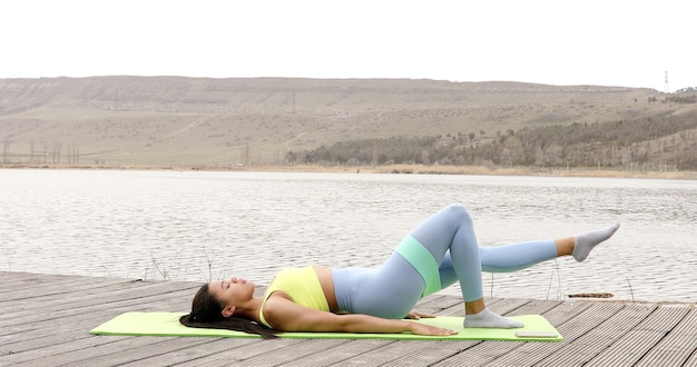 Fit woman doing exercise with resistance band.