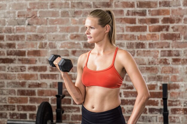  Fit woman exercising with dumbbell 