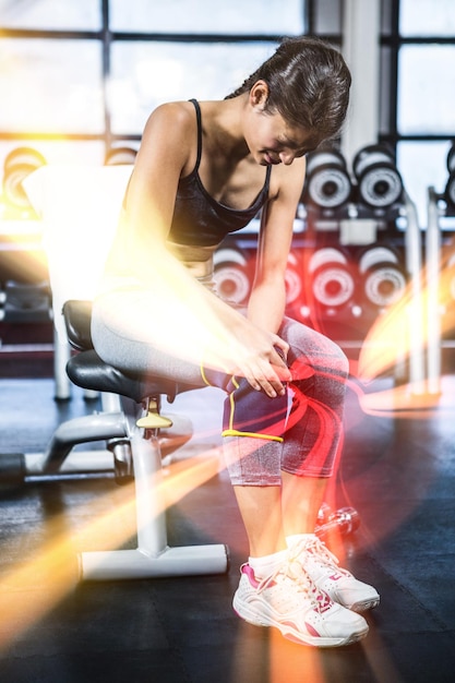 Fit woman having knees pain at gym