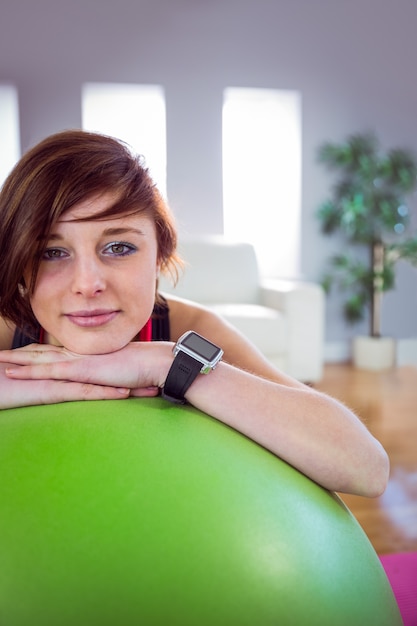 Fit woman leaning on exercise ball