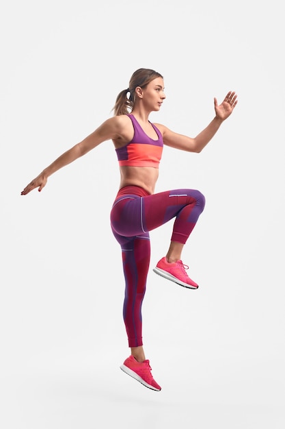 Fit woman leaping during training