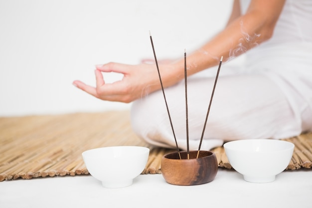 Fit woman meditating on bamboo mat