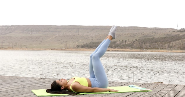 Fit woman practicing abdominal muscles workout.