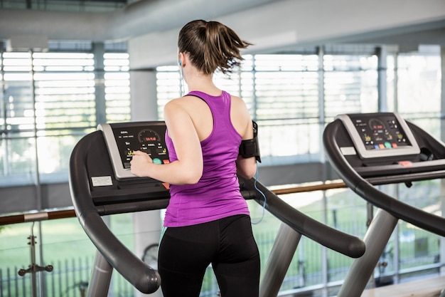 Fit woman running on treadmill at the gym